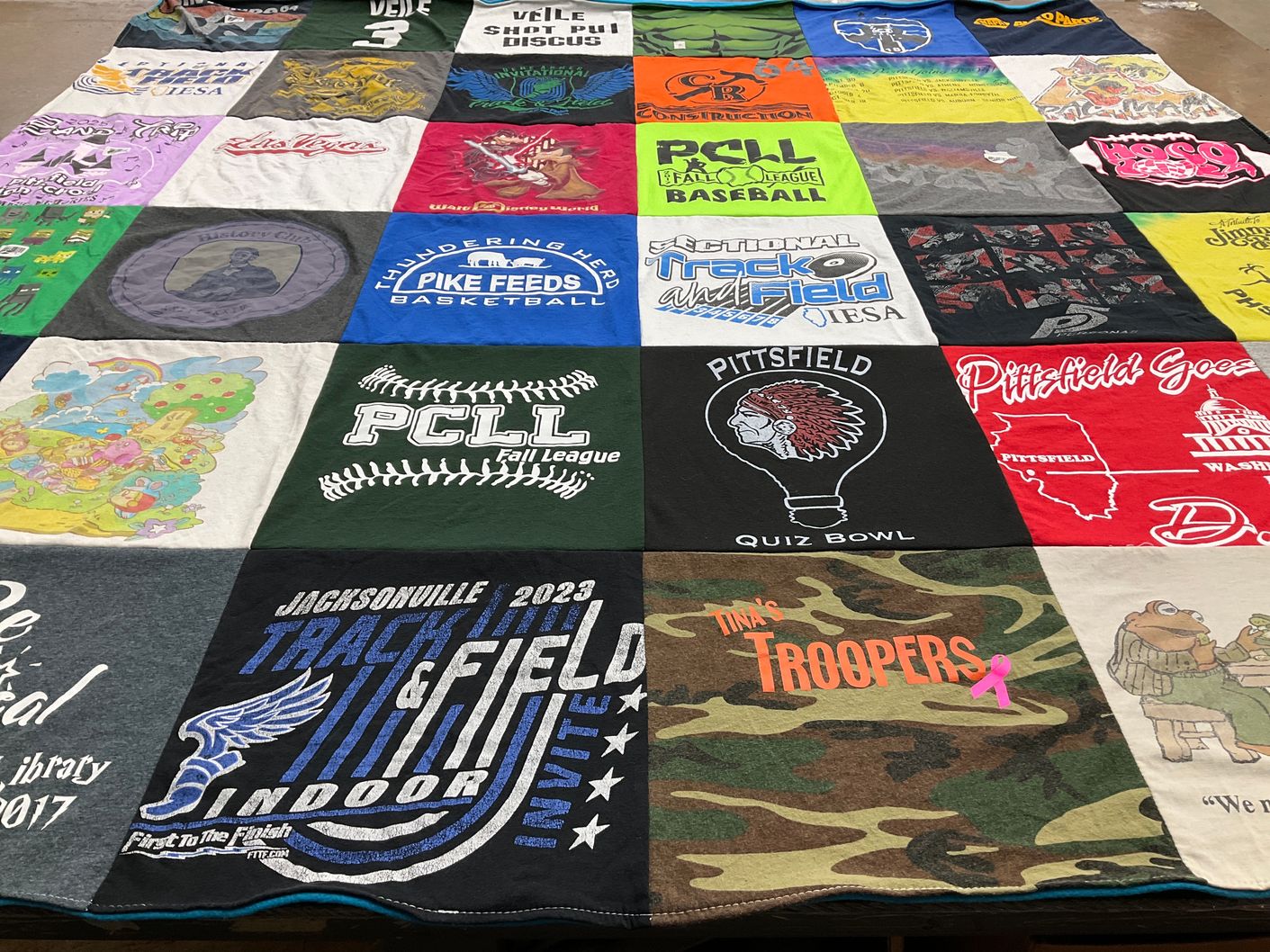 T-shirt quilt with sports, quizzes themes by Tina from IL