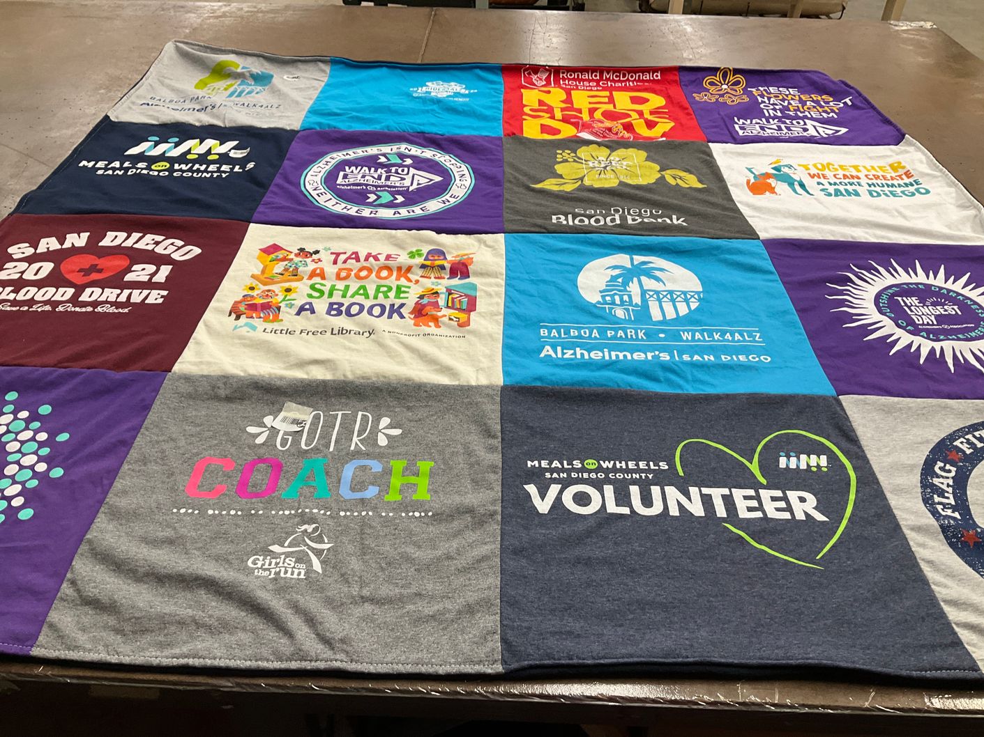 T-shirt quilt with community service, volunteering themes by Rita from CA