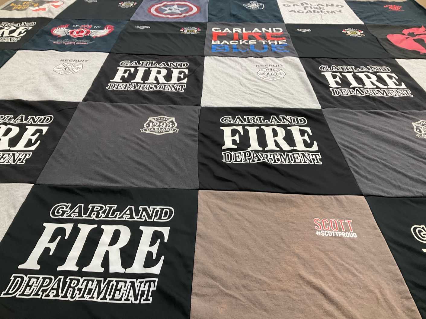 T-shirt quilt with firefighting, community service themes by Janette from TX