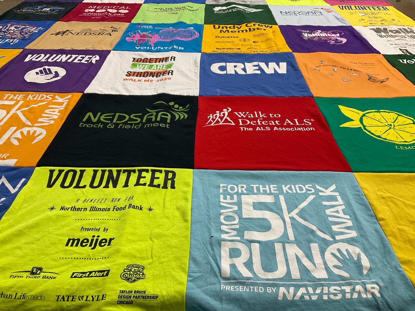T-shirt quilt with volunteering, running themes by Robin from IL