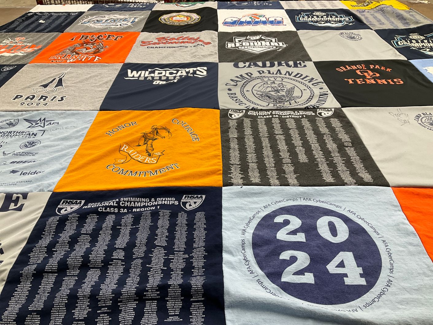 T-shirt quilt featuring wildcats baseball, raiders swim team by Sondra from FL
