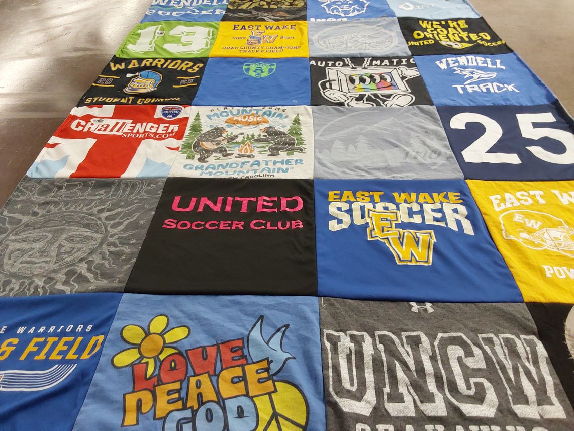 T-shirt quilt featuring east wake soccer team, east wake warriors track team by Brigit from NC