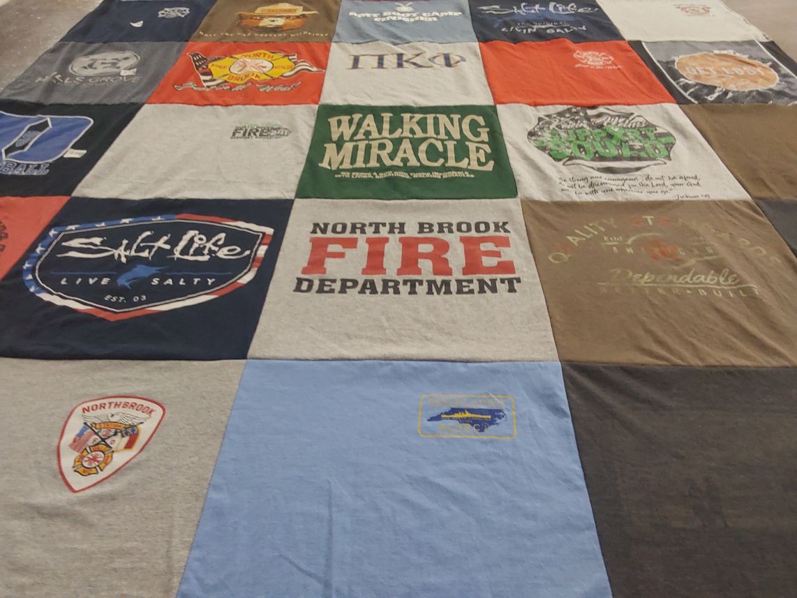T-shirt quilt with firefighting, fishing themes by Deanna  from NC