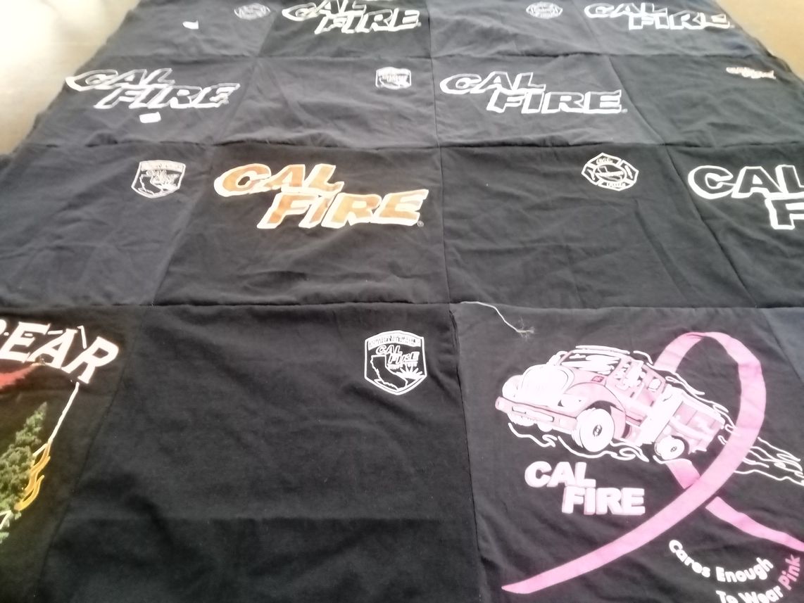 T-shirt quilt with firefighting, safety themes by Kimberley from CA