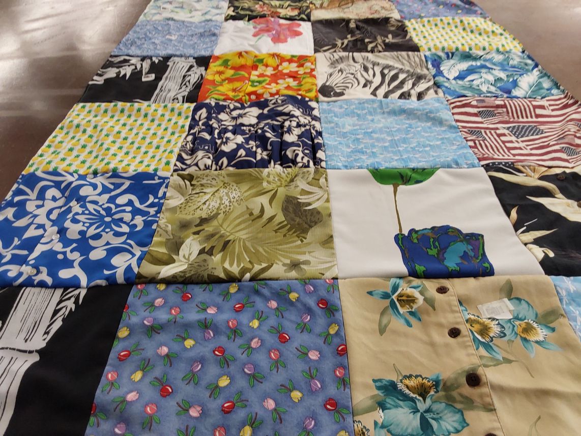 T-shirt quilt with quilting, fabric patterns themes by Aubri from CA