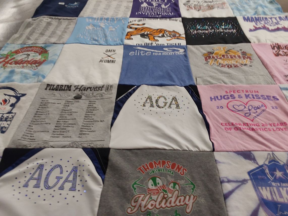 T-shirt quilt with gymnastics, hockey themes by Jill from MA
