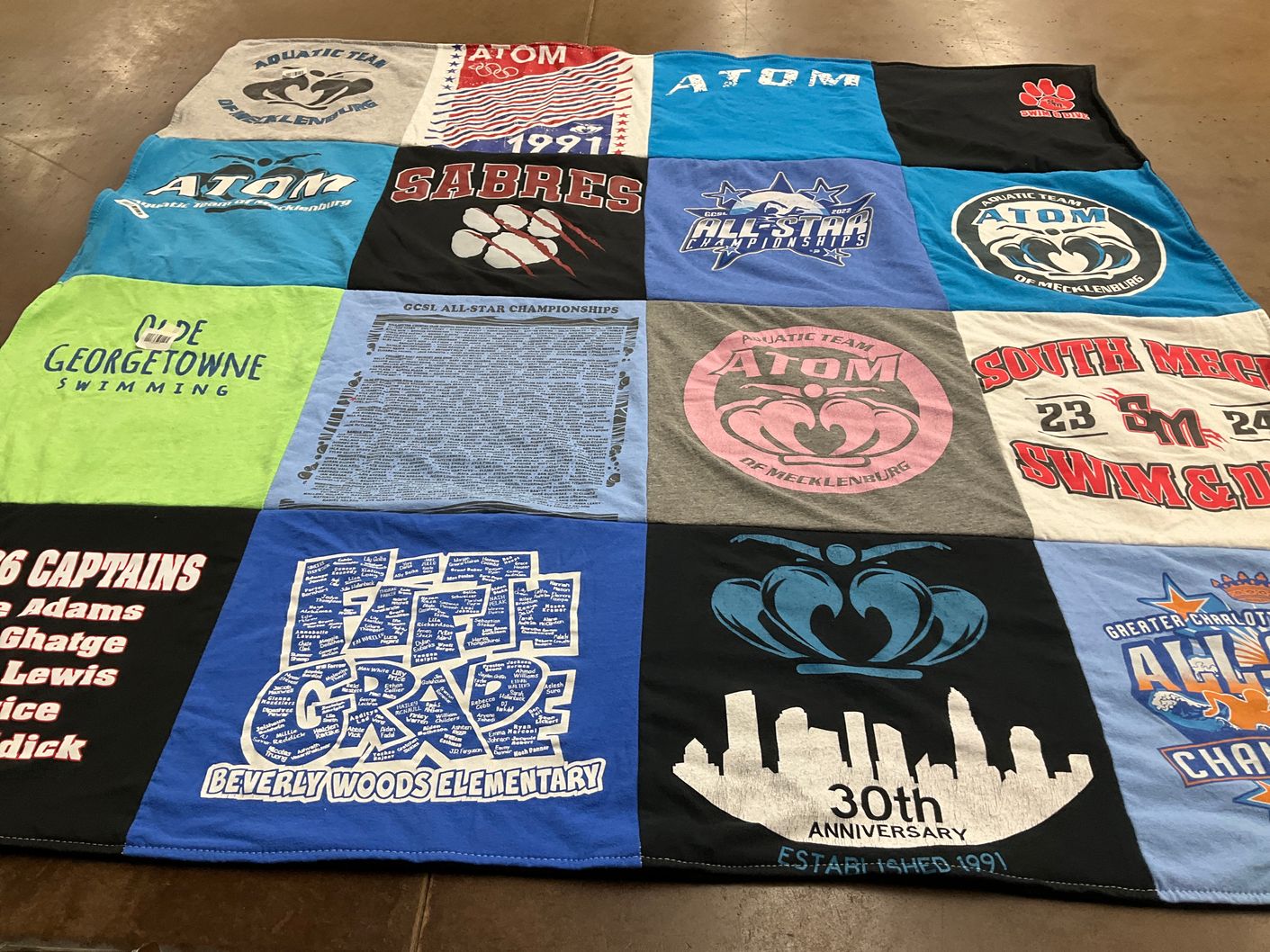 T-shirt quilt featuring aquatic team of mecklenburg, sabres by Anna from NC