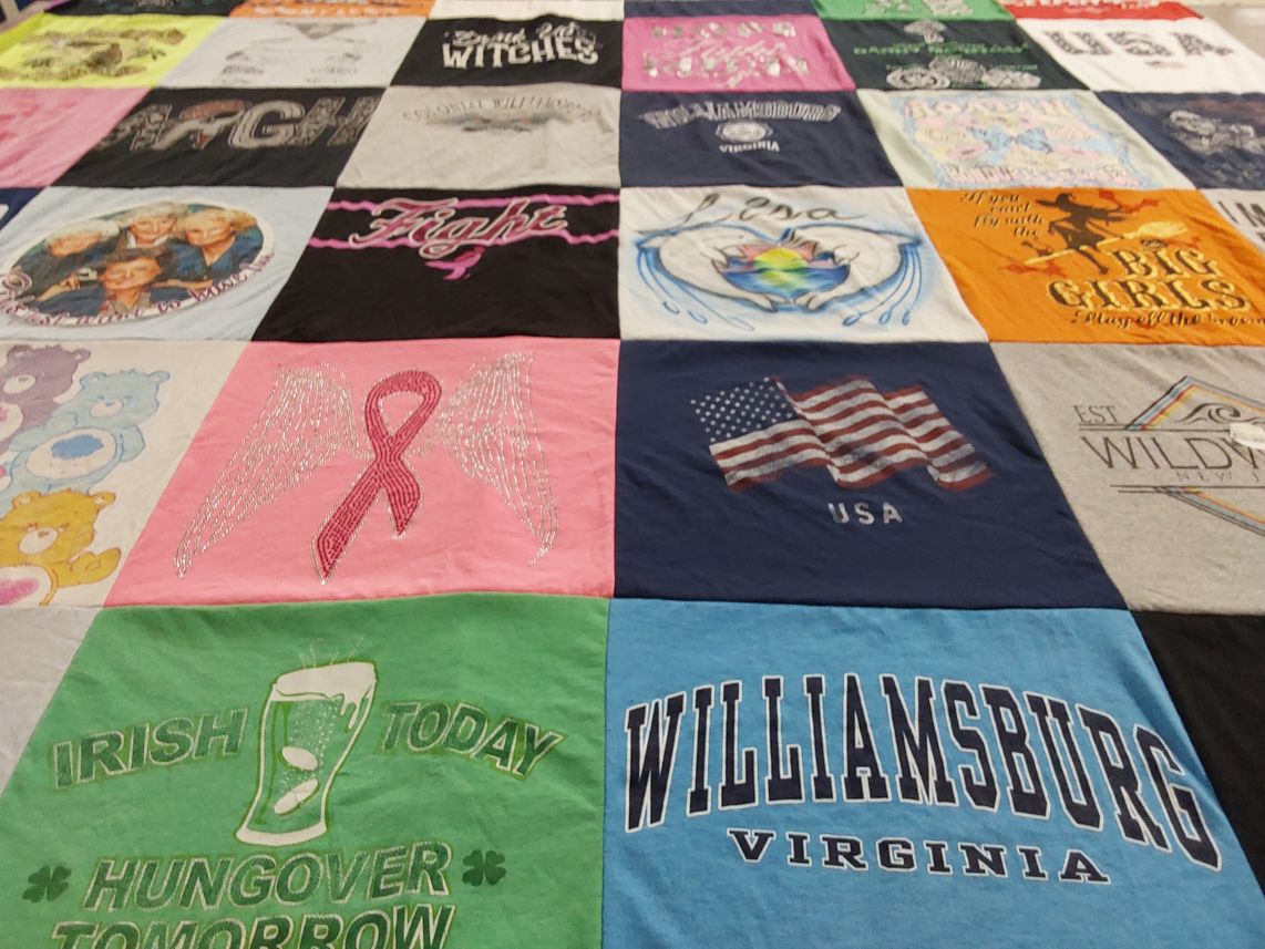 T-shirt quilt with breast cancer awareness, caring themes by Ira from PA