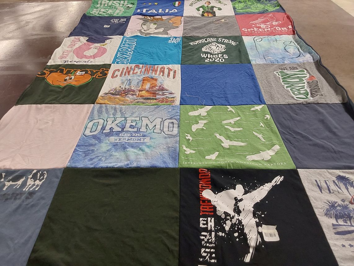 T-shirt quilt with skiing, traveling themes by Maria from VT