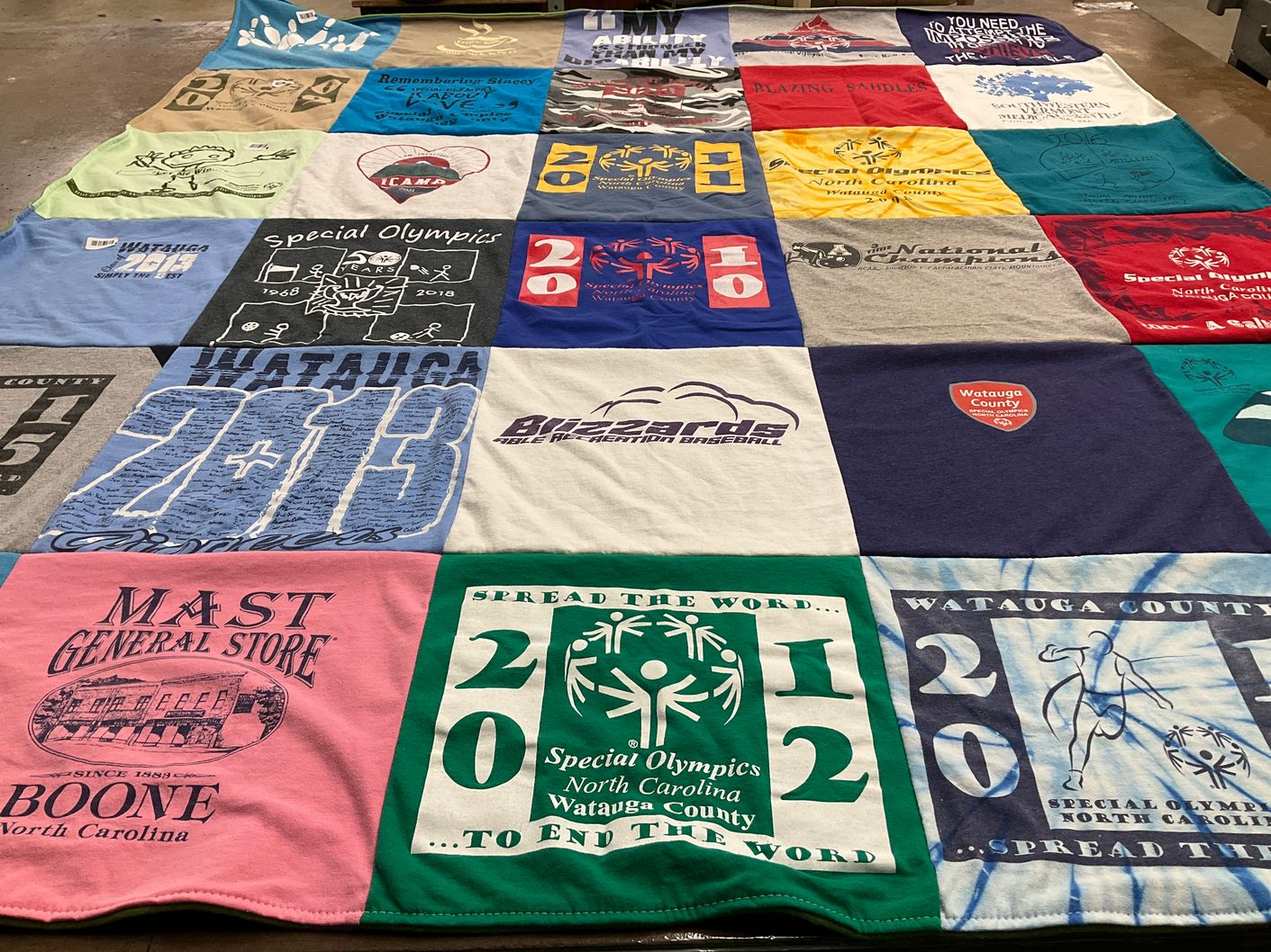 T-shirt quilt with community support, sports themes by Mary Jo from NC