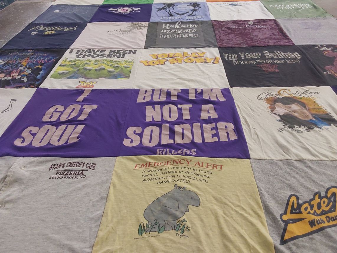 T-shirt quilt with films, music themes by Rebecca from NJ