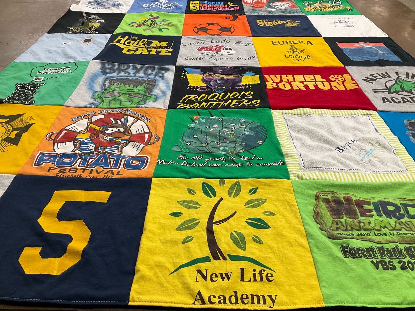 T-shirt quilt with festivals, education themes by Dalena from MI