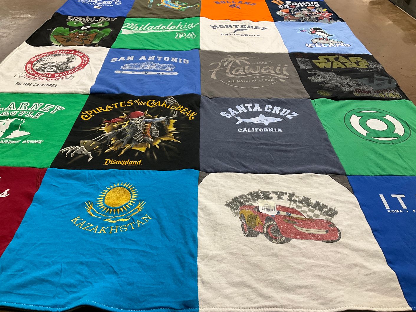 T-shirt quilt with travel, entertainment themes by rebecca from CA