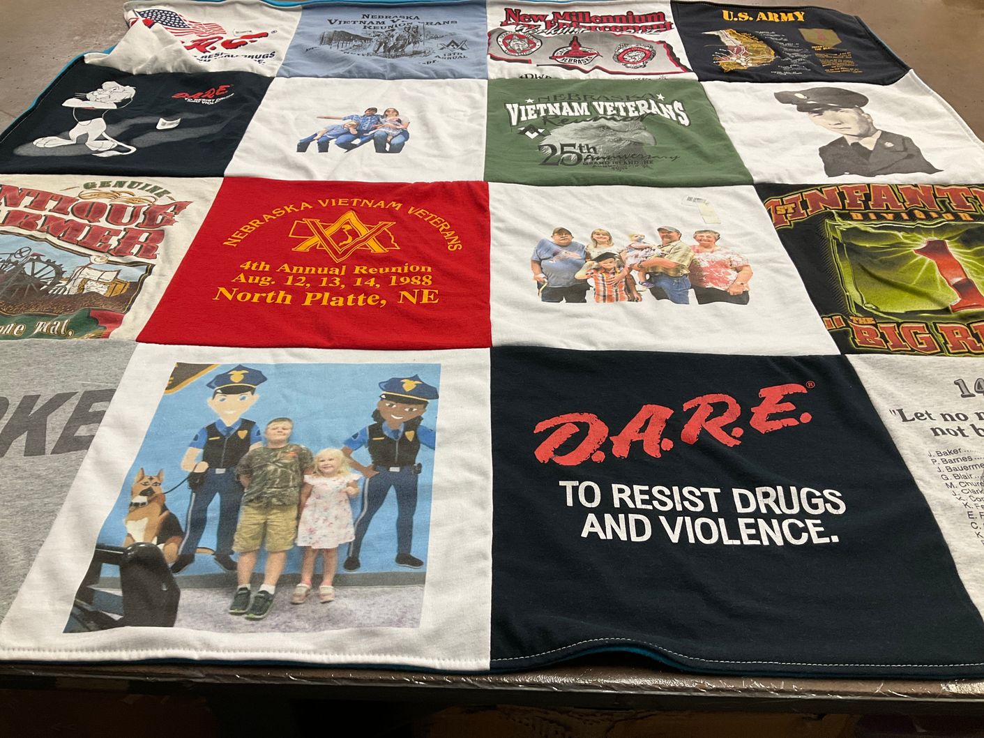 T-shirt quilt with veterans, community themes by Donna from NE