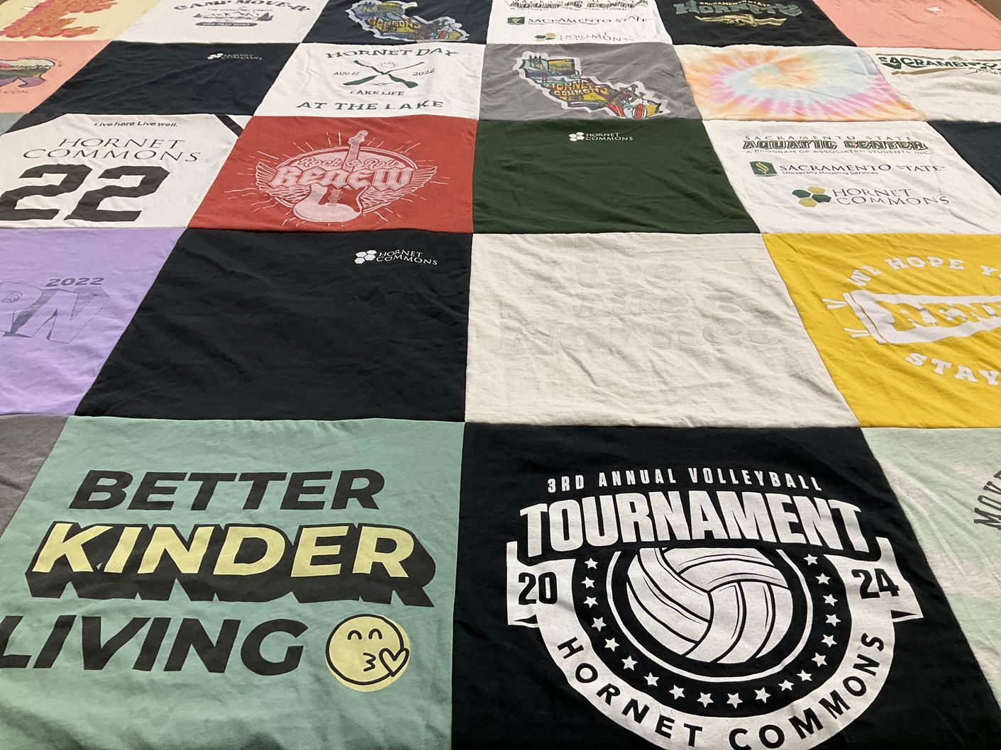 T-shirt quilt with community events, volleyball themes by Alexander from CA