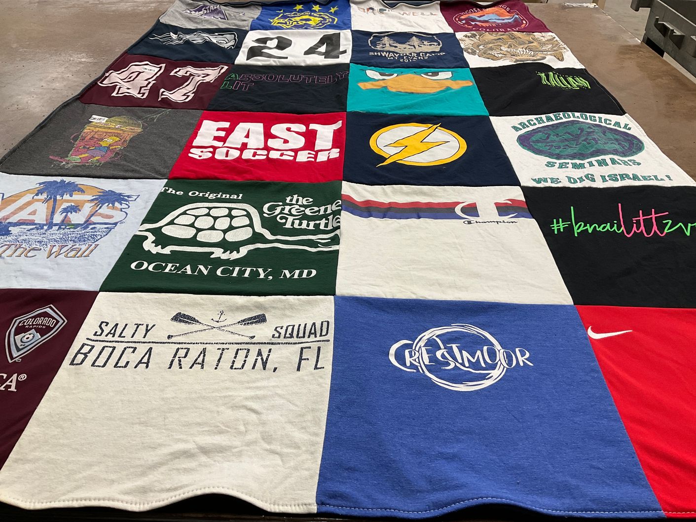 T-shirt quilt with sports, travel themes by Julie from CO