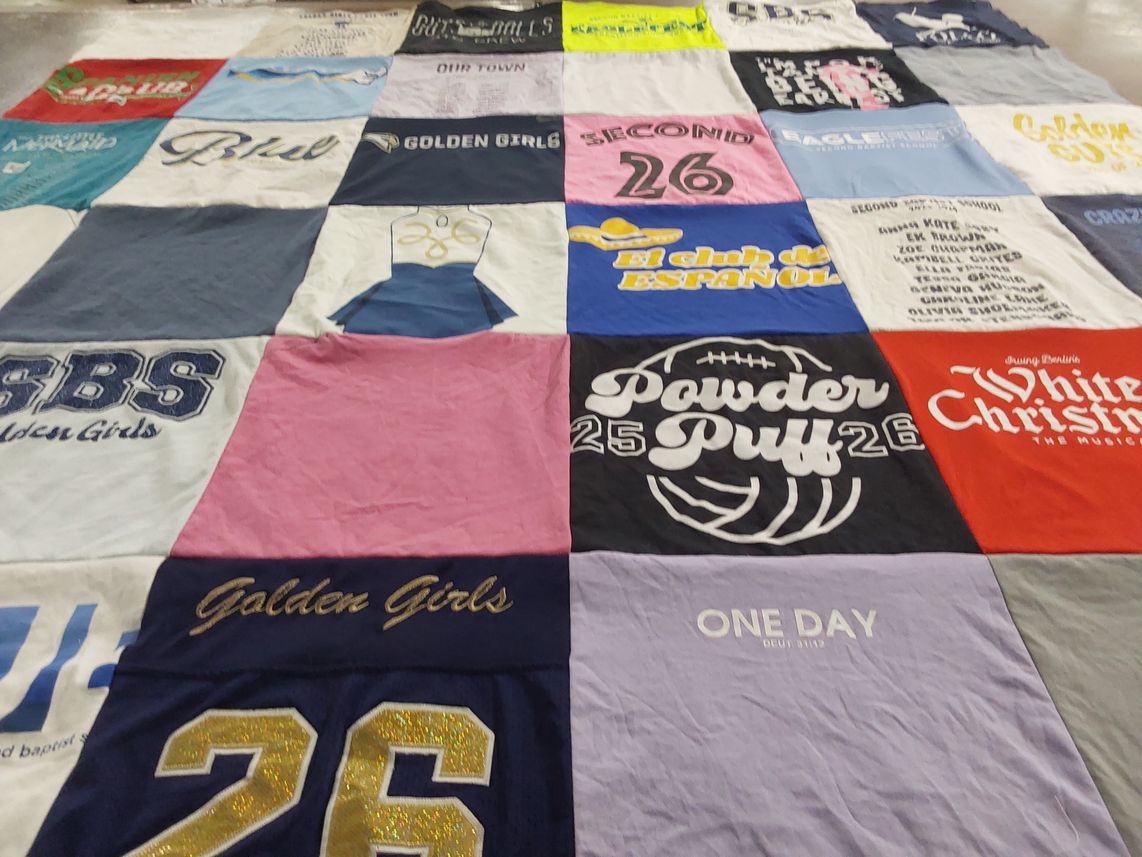 T-shirt quilt with community, theater themes by Rebecca from TX