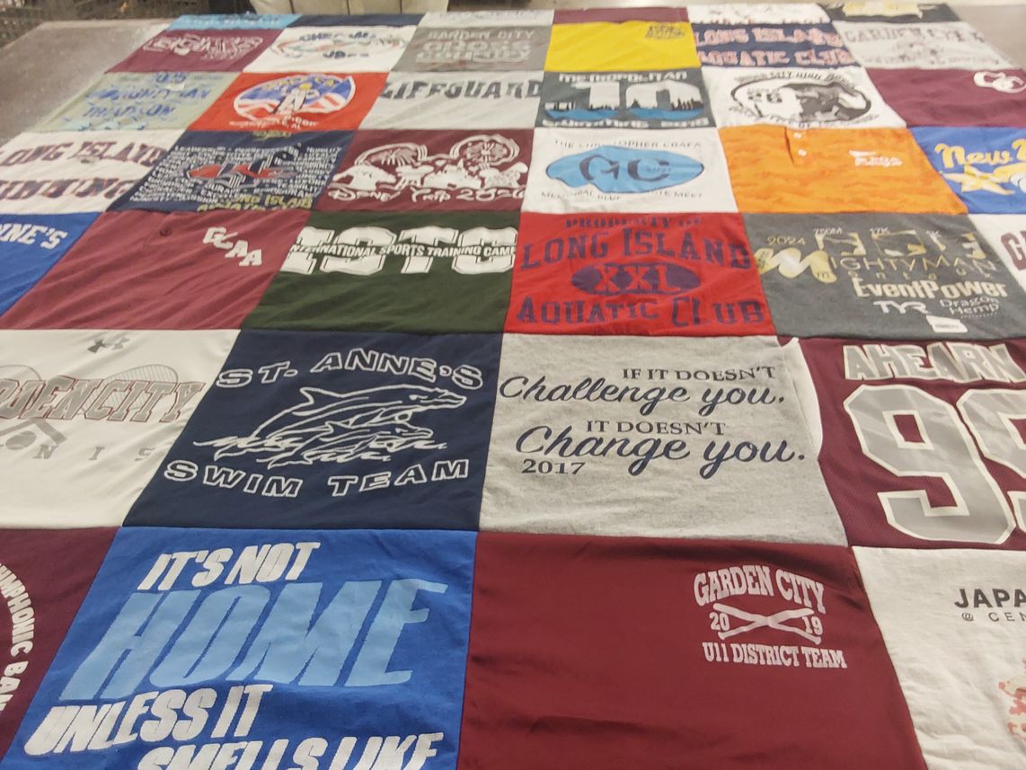 T-shirt quilt featuring st. anne's swim team, garden city u11 district team by Jennifer from NY
