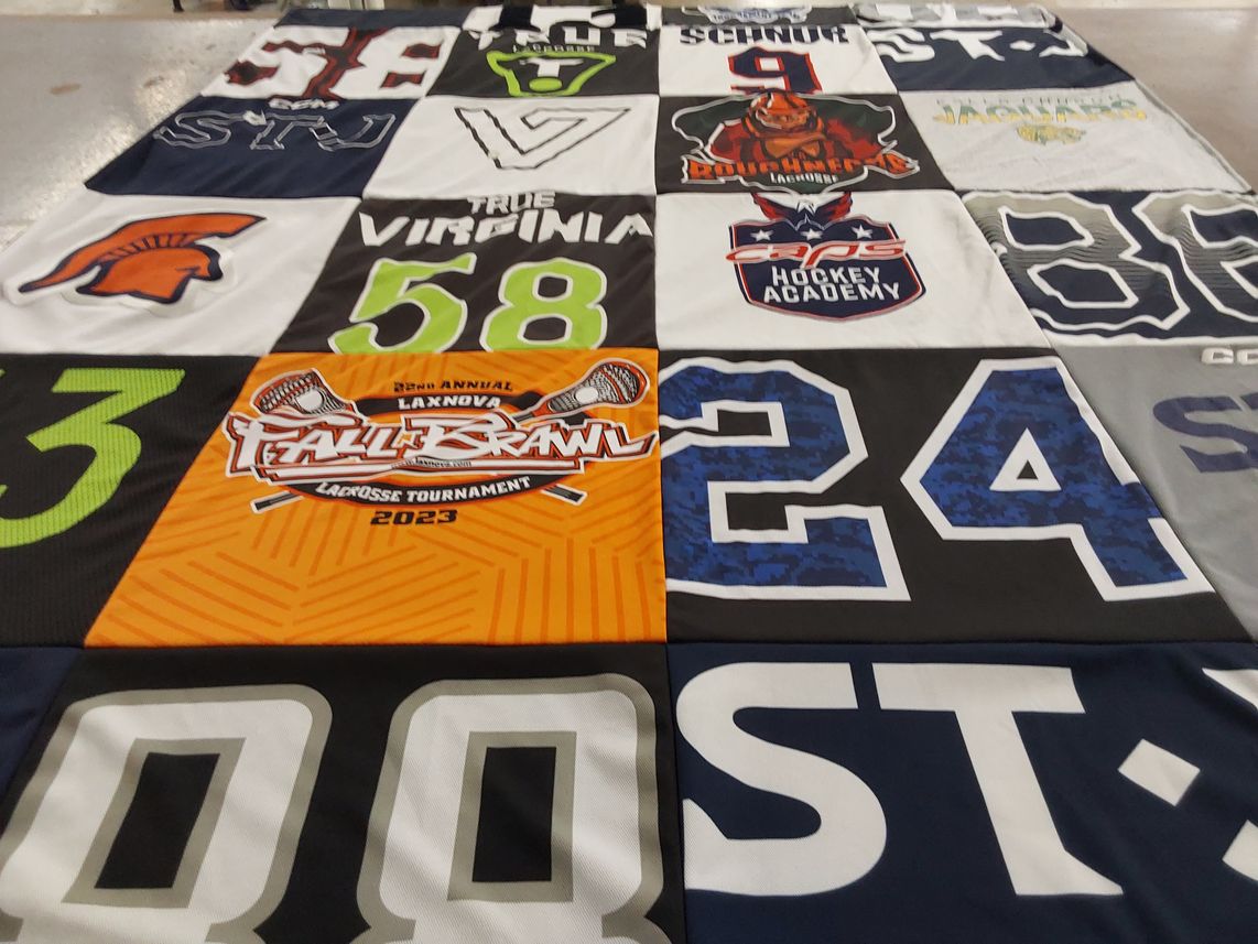 T-shirt quilt with lacrosse, hockey themes by Melinda from VA