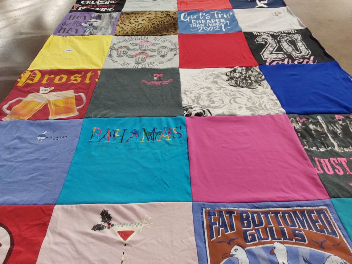 T-shirt quilt with travel, beverages themes by Kim from GA