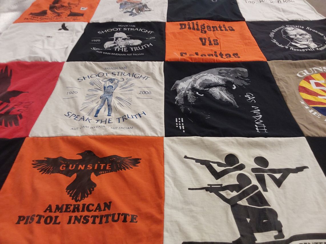T-shirt quilt with shooting, firearms themes by Peggy from TX