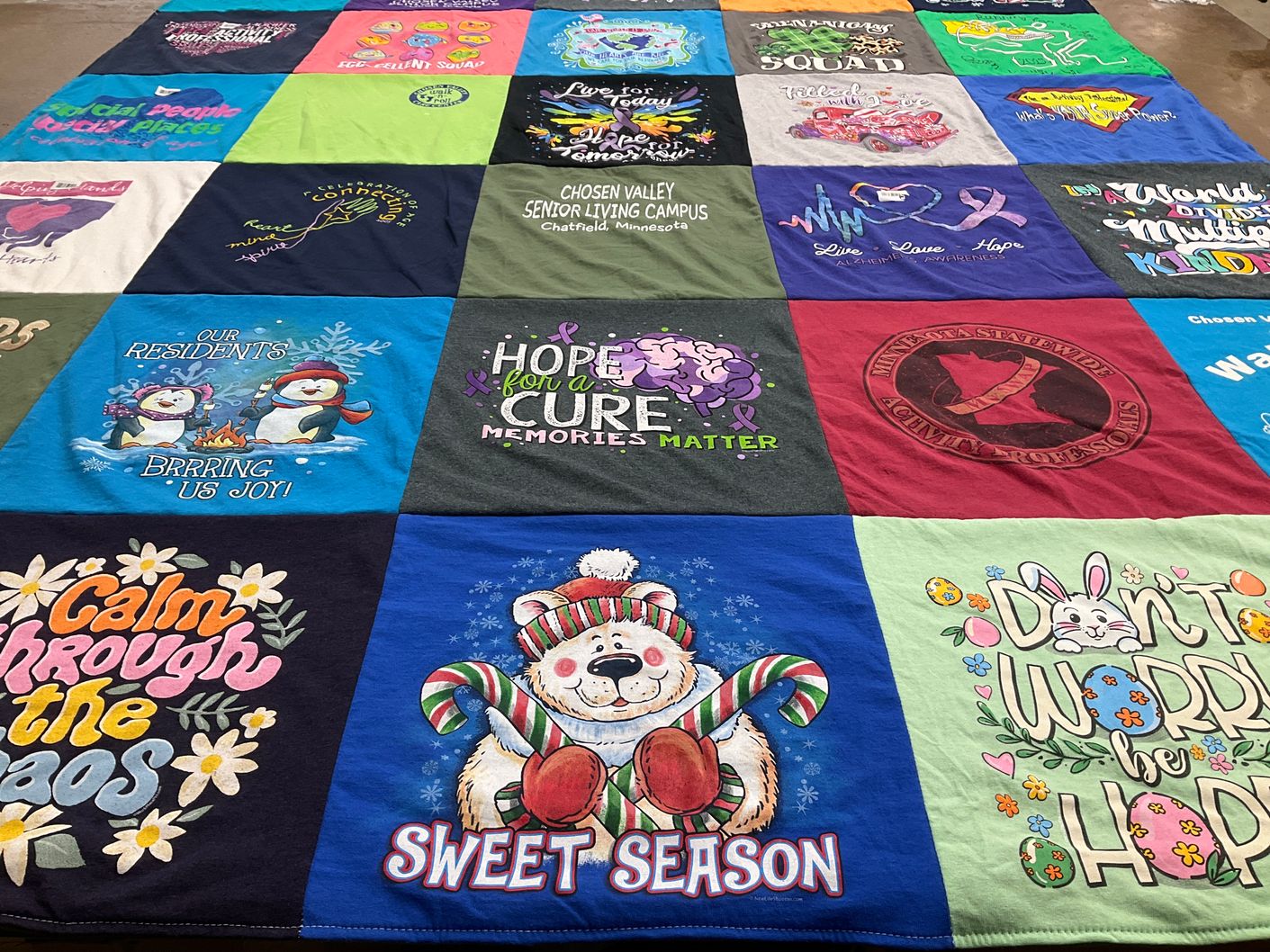 T-shirt quilt with community, senior living themes by Kathy from MN