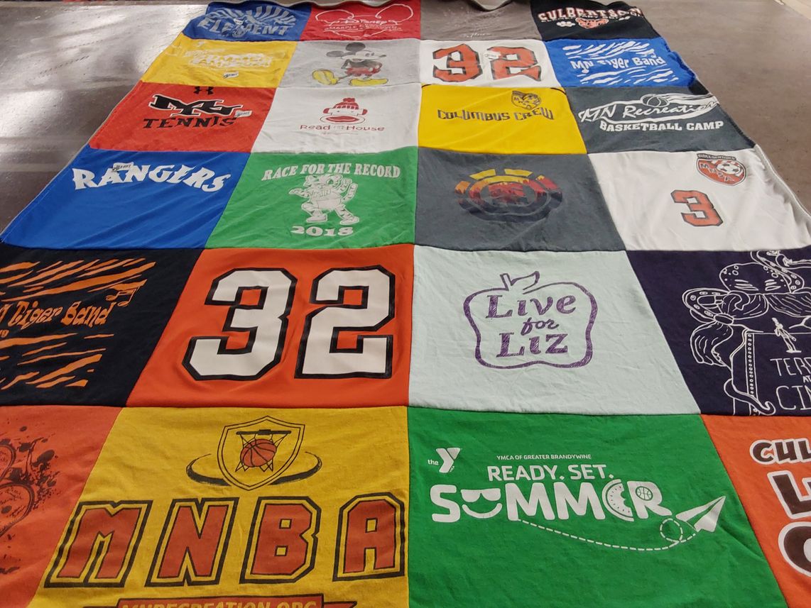 T-shirt quilt with sports, music themes by Amy from PA