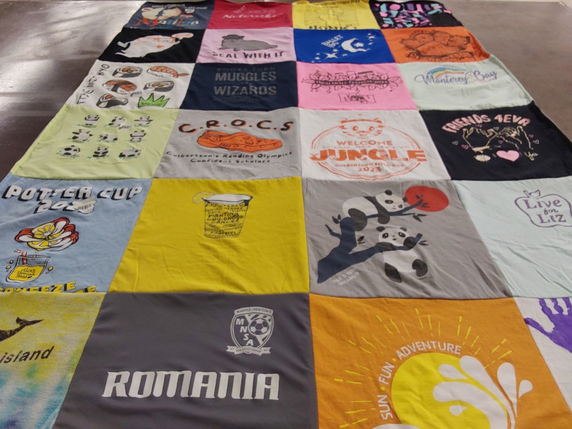 T-shirt quilt with reading, sports themes by Amy from PA