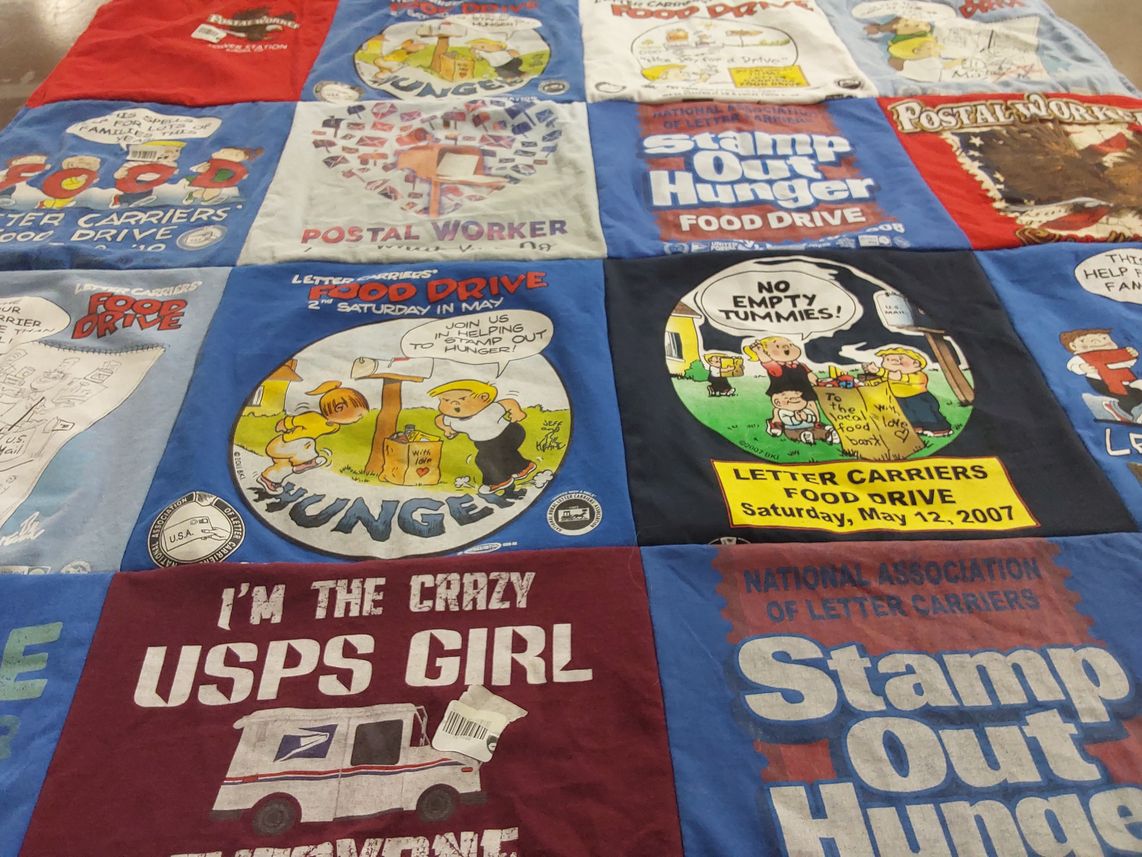 T-shirt quilt with community service, food drives themes by Katherine  from CO