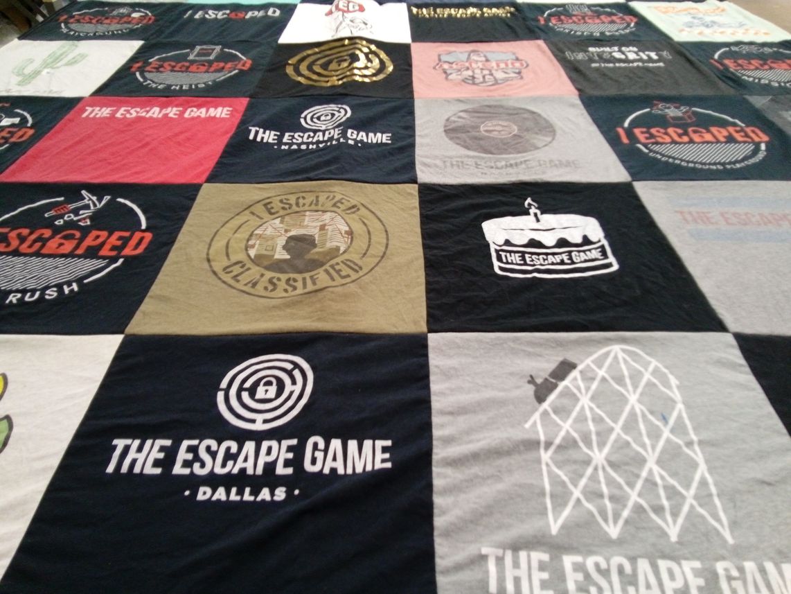 T-shirt quilt with escape rooms, puzzles themes by Marissa from TN