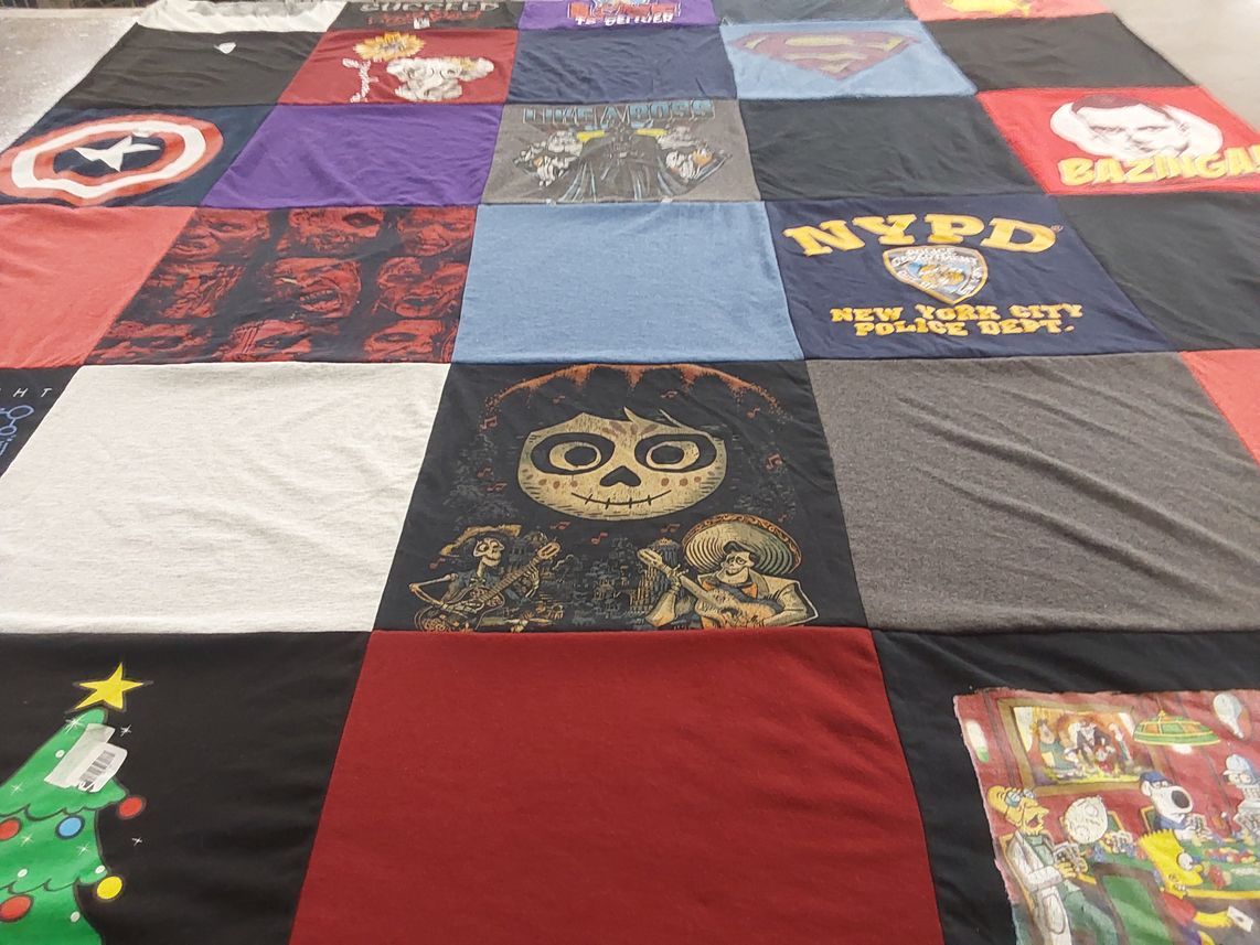 T-shirt quilt with superheroes, crime themes by Edna from NY