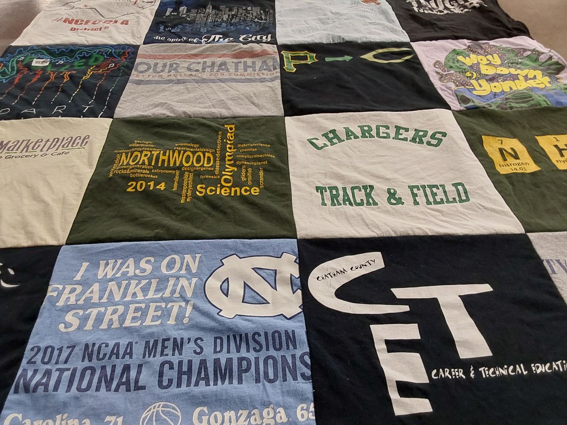T-shirt quilt featuring chargers track and field, university of north carolina men's basketball team by Jake from NC