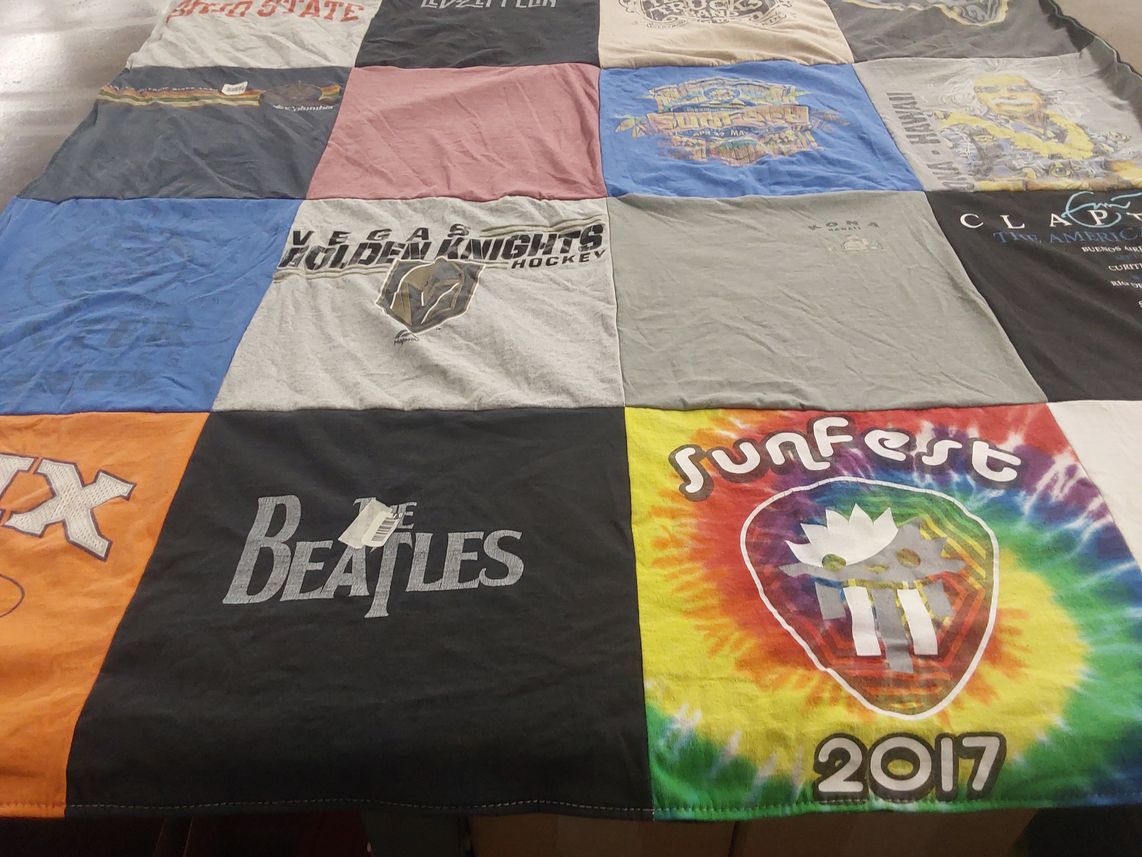 T-shirt quilt with music, hockey themes by Heather from FL