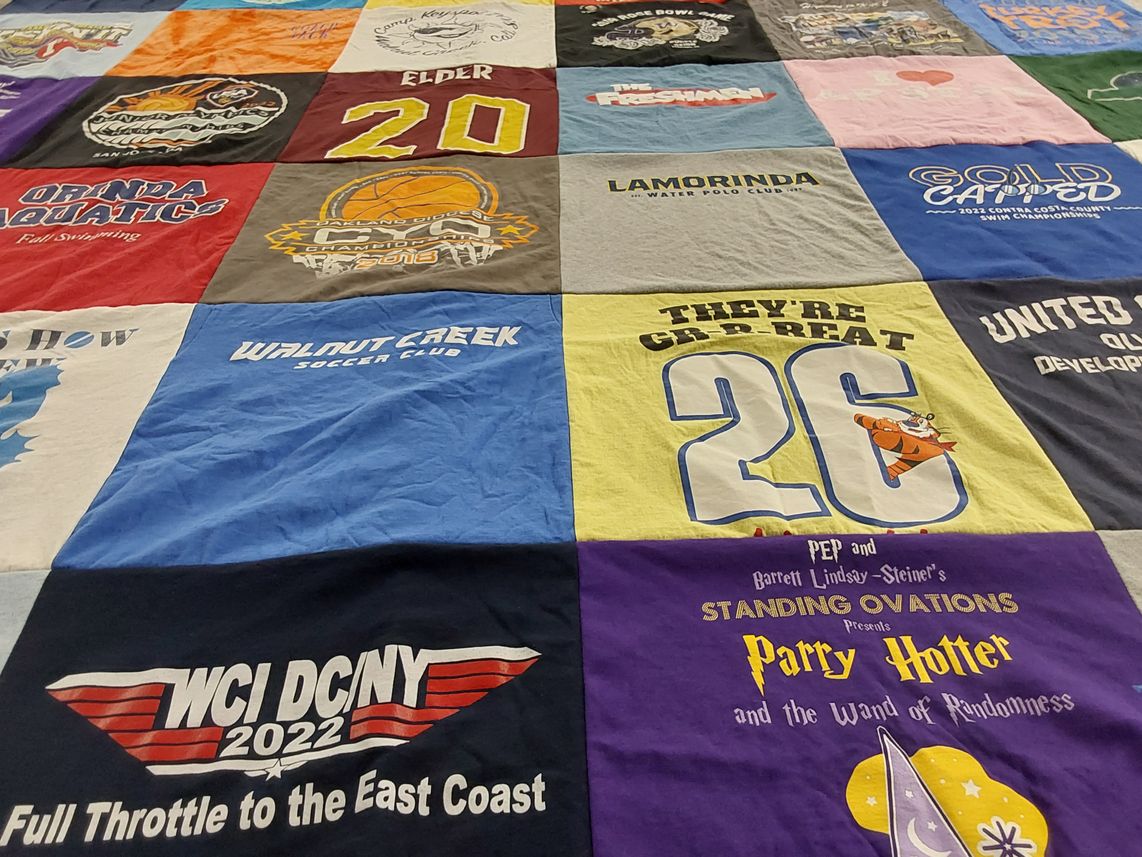 T-shirt quilt with swimming, soccer themes by Heather from CA