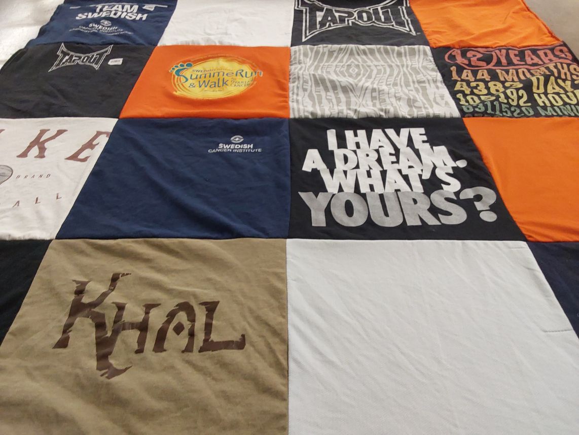 T-shirt quilt with running, cancer awareness themes by Kathy from AZ