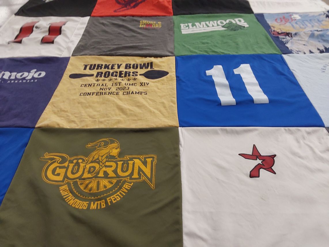 T-shirt quilt with cycling, festivals themes by Leslie from AR