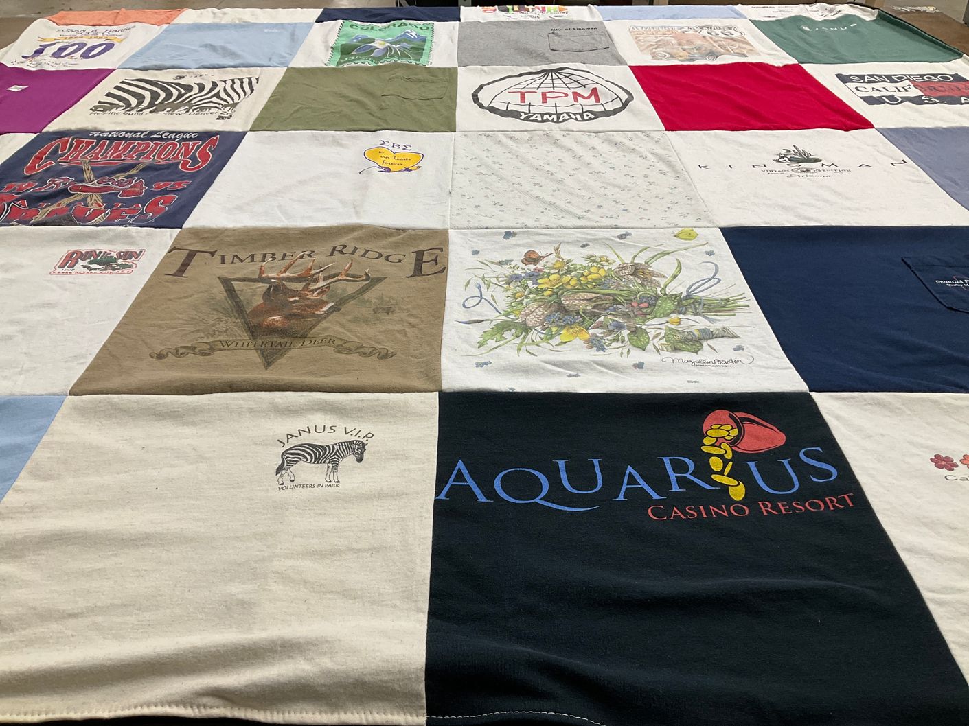 T-shirt quilt with casinos, volunteering themes by Kara from OR