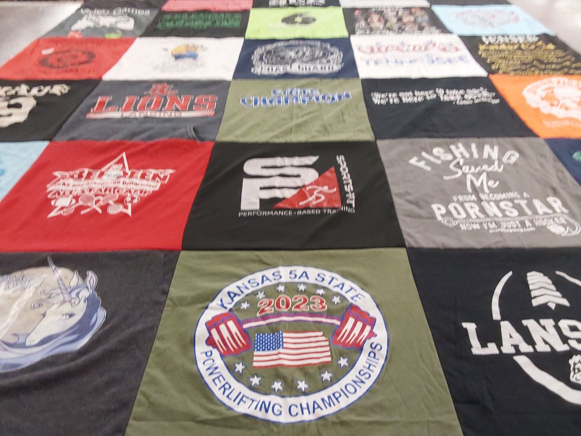 T-shirt quilt with fishing, powerlifting themes by Clover from KS