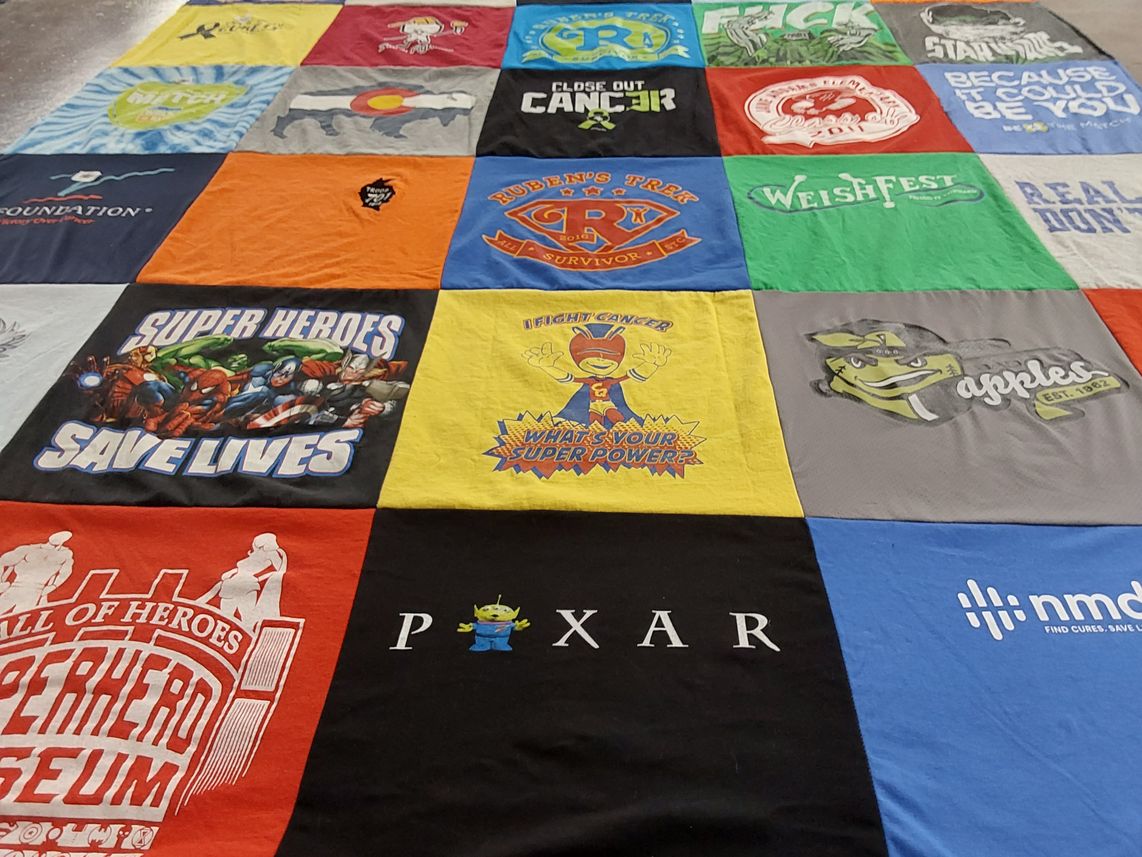 T-shirt quilt with superheroes, cancer awareness themes by Sandra from IL