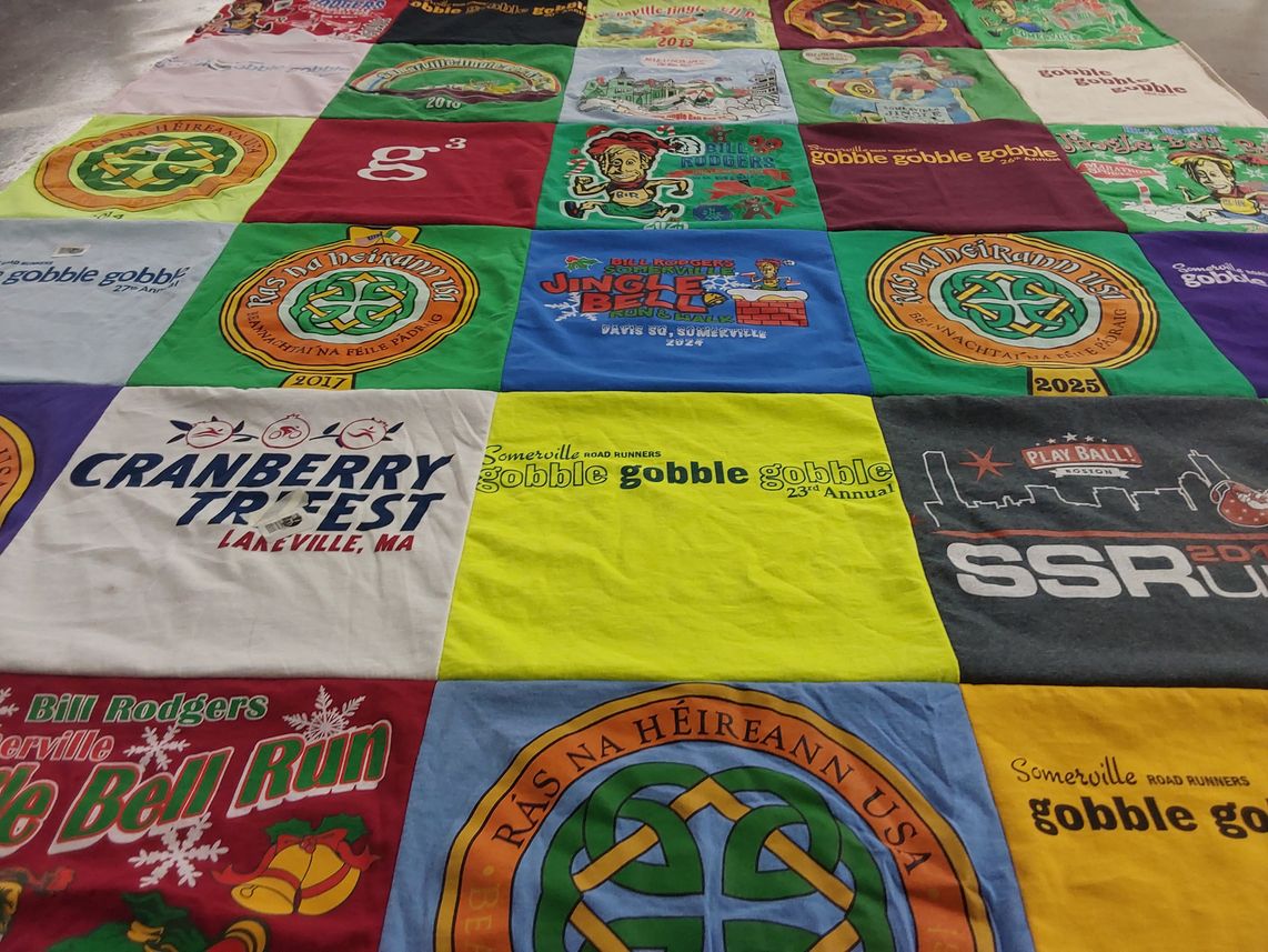T-shirt quilt with running, community events themes by Katie from MA