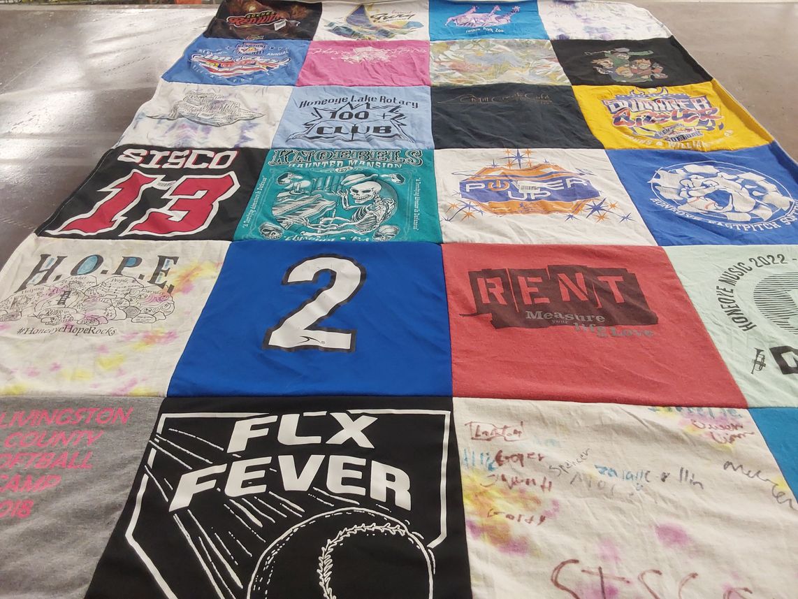 T-shirt quilt with theater, community themes by Migna from NY