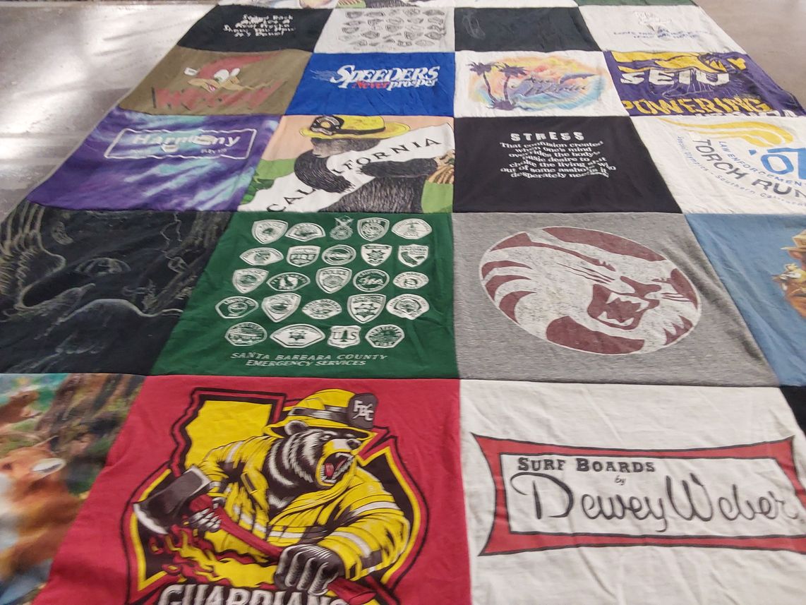 T-shirt quilt with surfing, emergency services themes by Laura from CA