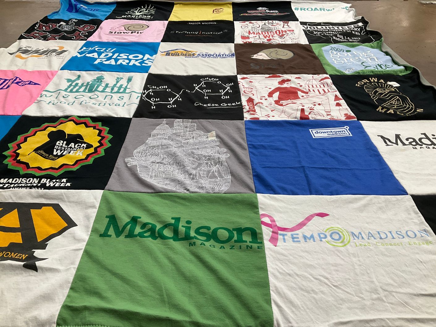 T-shirt quilt with community events, food festivals themes by Tiffany from WI