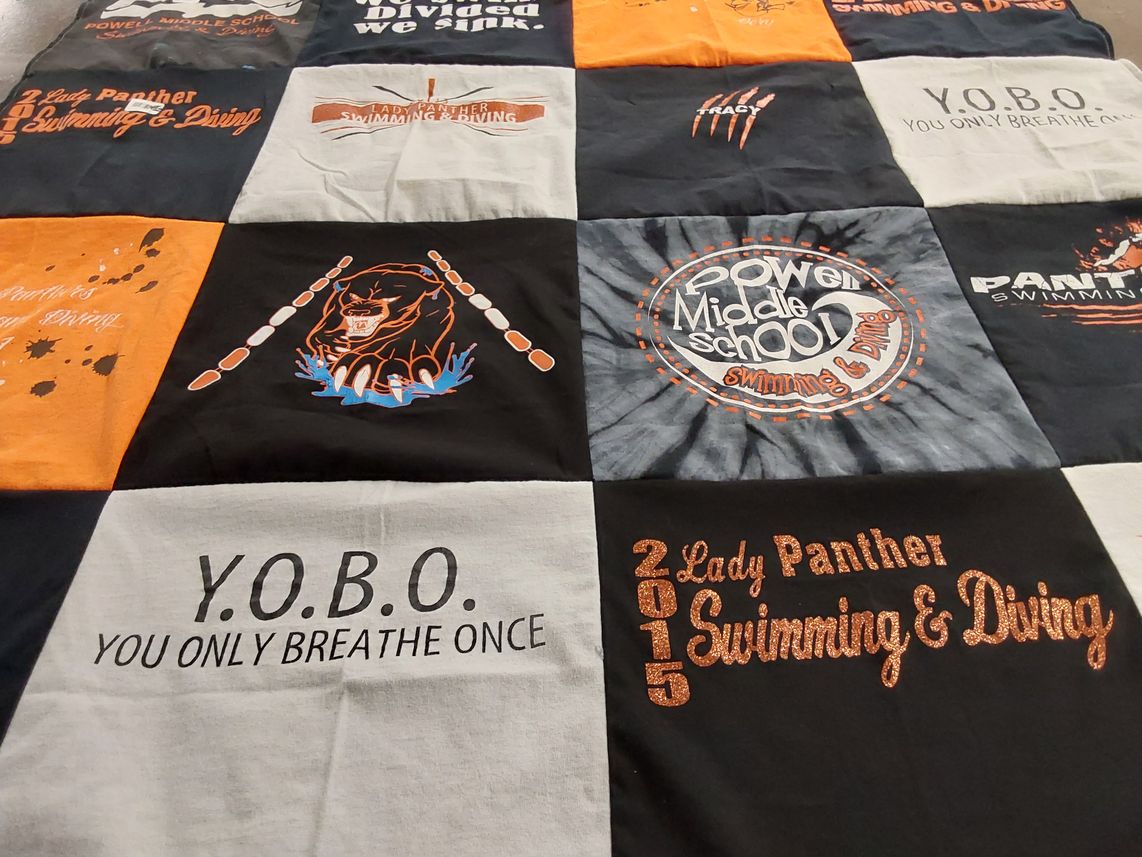 T-shirt quilt featuring lady panther swimming and diving by Kari from WY