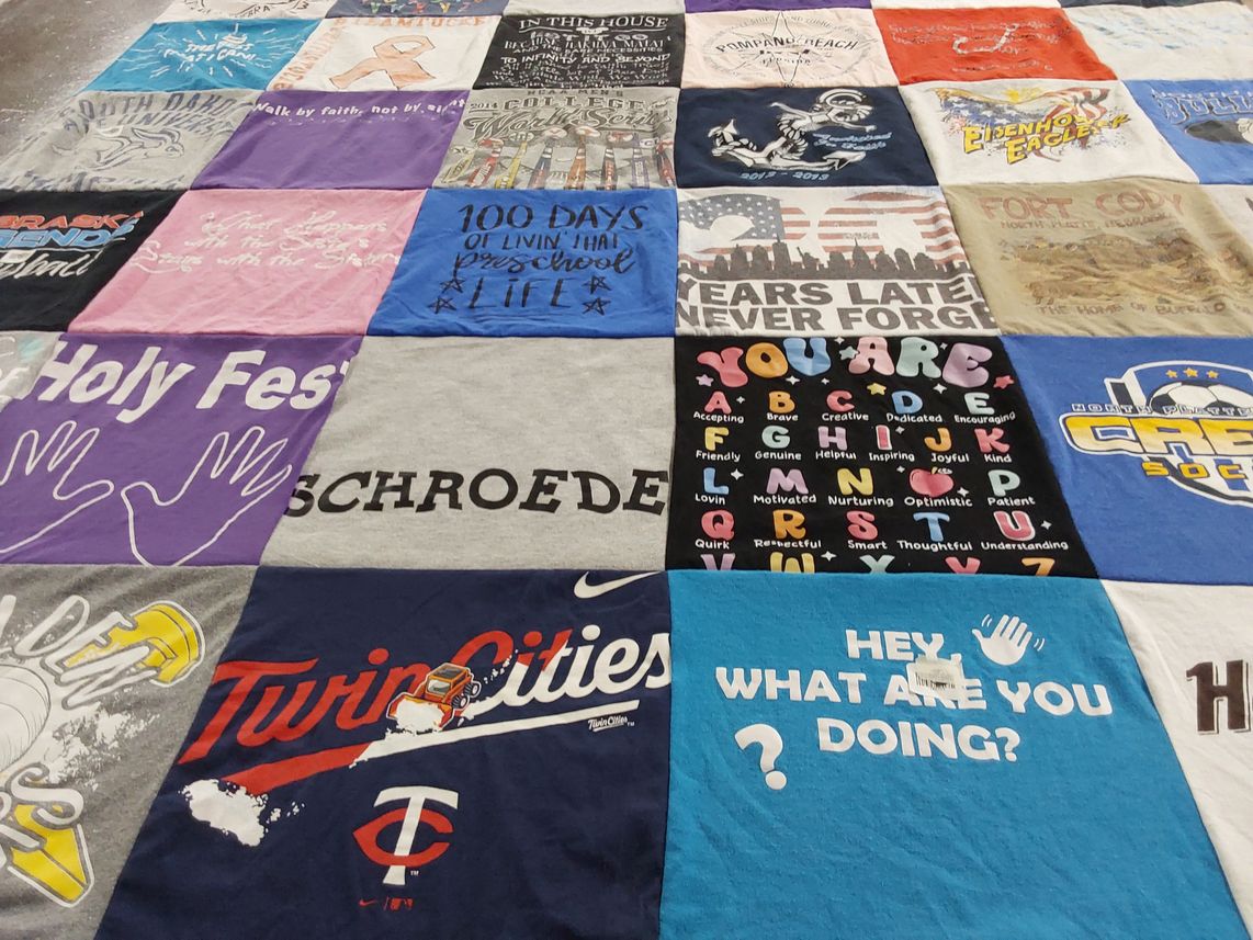T-shirt quilt with education, community themes by kathy from NE