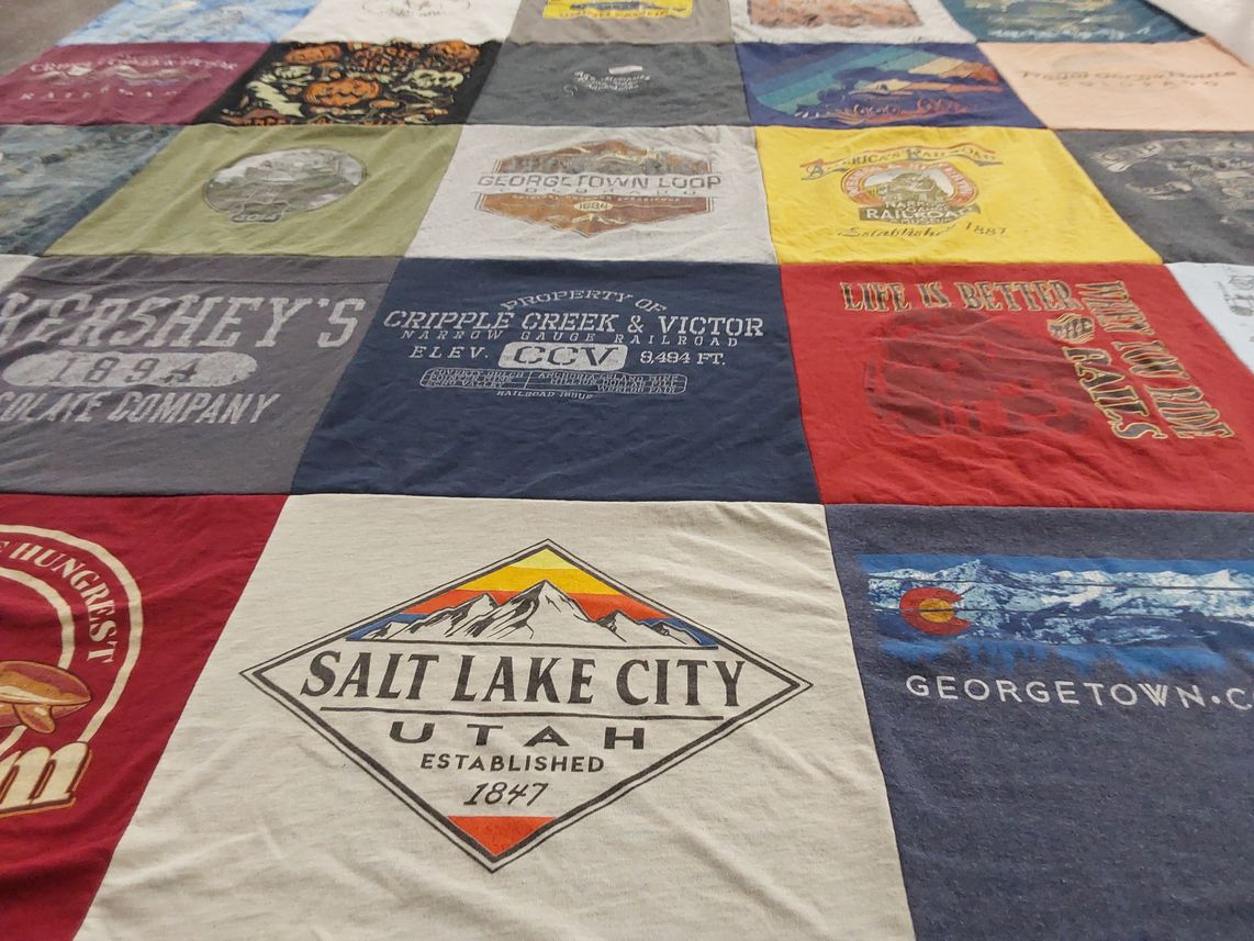 T-shirt quilt with travel, chocolate themes by Beth from CO
