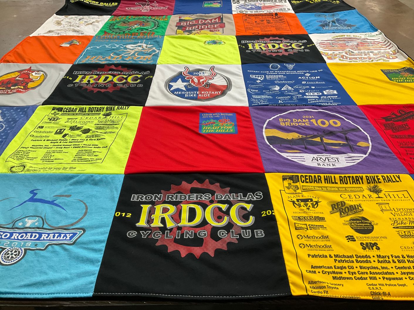 T-shirt quilt with cycling, community events themes by Dorothy from TX