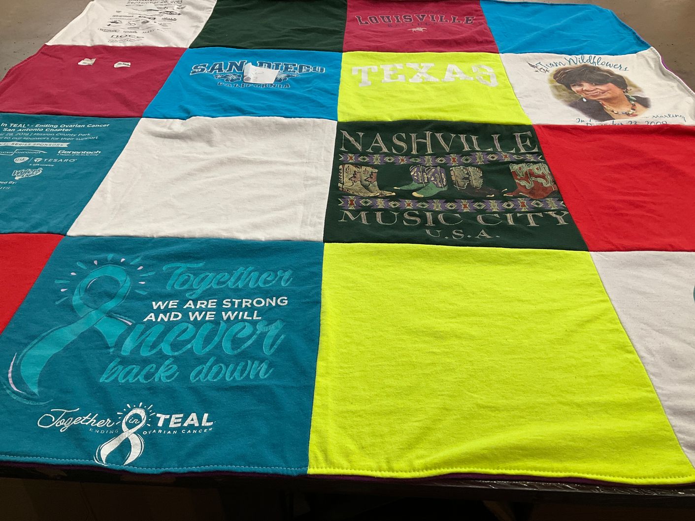 T-shirt quilt with ovarian cancer awareness themes by Hope from TX
