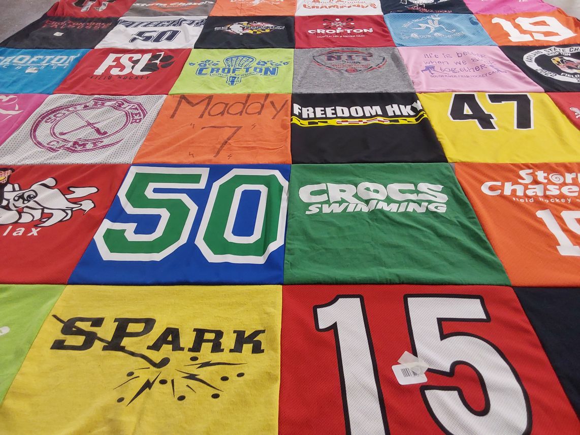 T-shirt quilt with field hockey, swimming themes by Karen from MD
