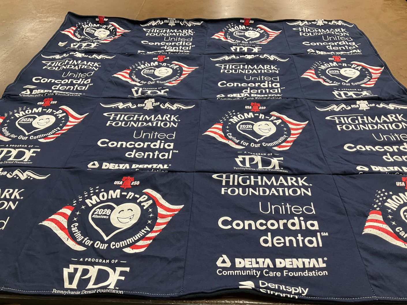 T-shirt quilt with community care, dental health themes by Linda from PA
